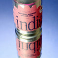 Load image into Gallery viewer, A cold can of indigo Raspberry, Habanero and Lime Soda with water droplets, reflected on a glossy blue surface
