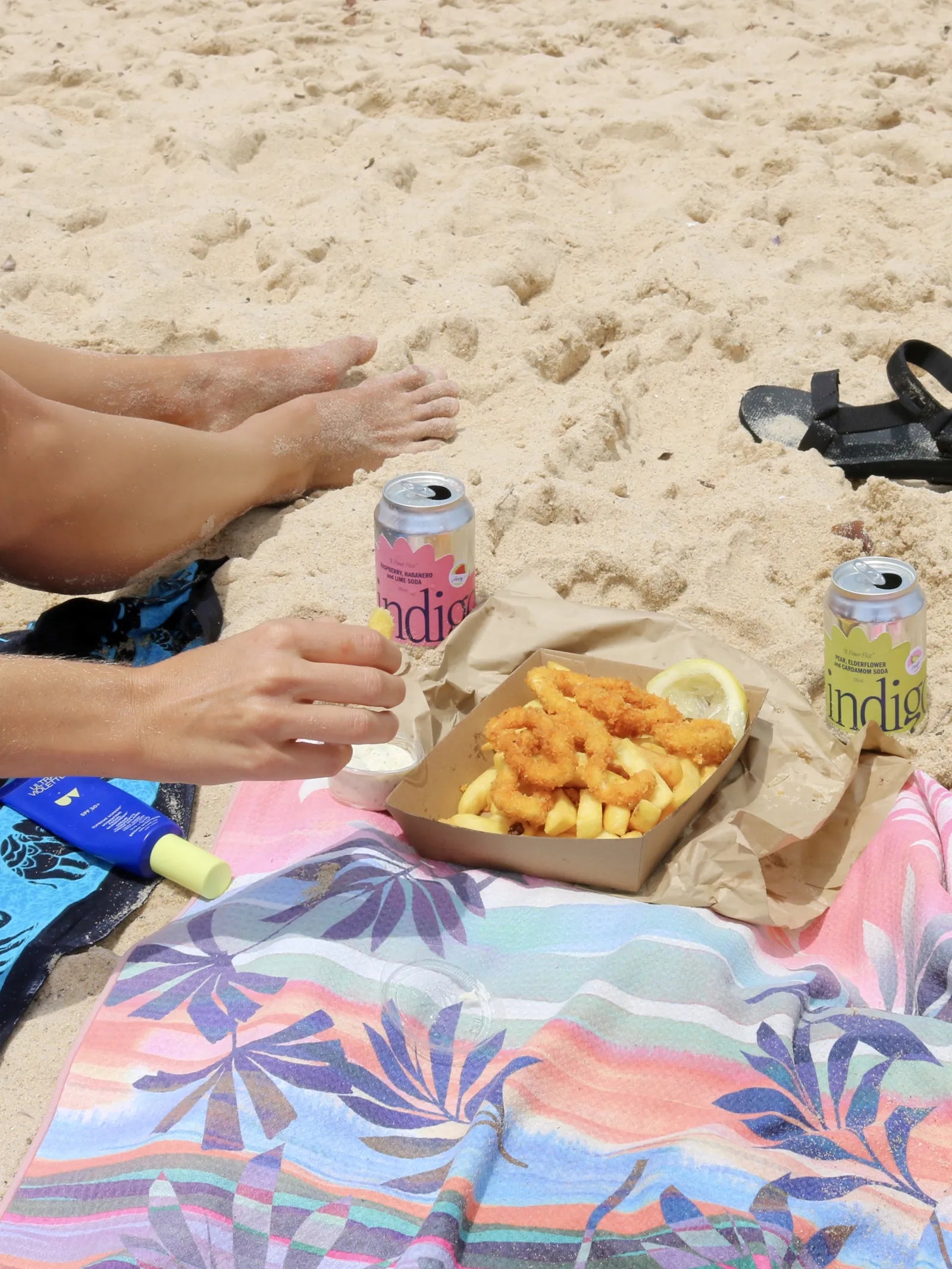 indigo Raspberry, Habanero & Lime and Pear, Elderflower & Cardamom sodas with calamari and chips on a beach towel